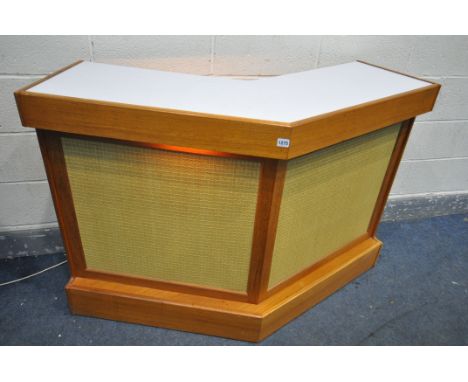 A MID CENTURY TURNIDGE OF LONDON TEAK ANGLED DRINKS BAR, with a synthetic woven panel front, white Formica top, and various s