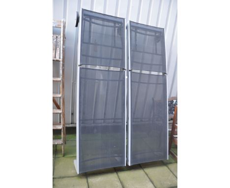 TWO MODERN GARDEN LOUNGERS with metal frames and woven coverings