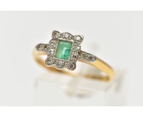 A YELLOW METAL EMERALD AND DIAMOND CLUSTER RING, set with a central rectangular cut emerald, within a surround of milgrain se