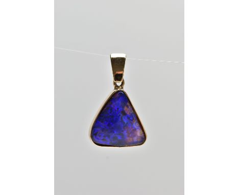 A YELLOW METAL OPAL PENDANT, of a triangular form, set with an opal cabochon displaying blues and purples, collet set into a 