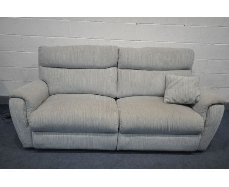 A BEIGE UPHOLSTERED THREE SEATER ELECTRIC RECLINING SOFA (condition - signs of usage, PAT pass and working)