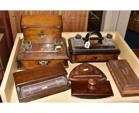 THREE SETS OF VICTORIAN AND EDWARDIAN CUT GLASS INK WELLS AND STANDS, comprising a mahogany ink stand with an ebonized handle