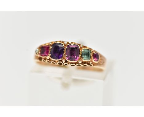 A GEM SET RING, set with six Vari cut gemstones such as emerald, amethyst, ruby, diamond etc, scrolling detail to the gallery