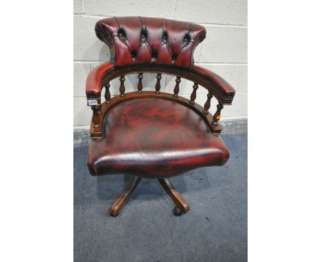 A BURGUNDY LEATHER UPHOLSTERED SWIVEL OFFICE CHAIR, with shaped button back, width 65cm x depth 67cm x height 86cm (good cond