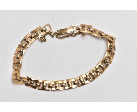A 9CT GOLD BRACELET, featuring a series of square links with ball detailing, fitted with a fold over clasp and additional saf