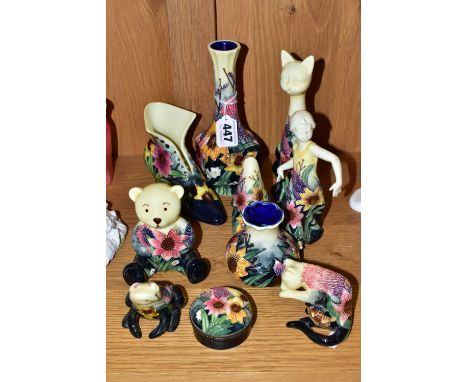 A COLLECTION OF OLD TUPTON WARE, with tube lined flowers on a cream to navy graduating ground, to include a square bodied bud