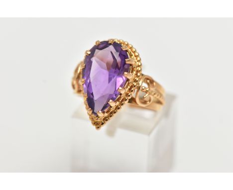 AN 18CT GOLD AMETHYST RING, designed with a pear cut amethyst, in a thirteen claw setting, measuring approximately length 16.