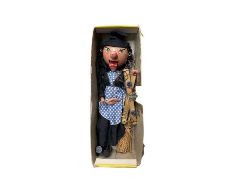 A 1950s/1960s SM Witch Pelham puppet with broomstick, in original half box.