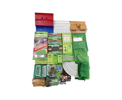 A large quantity of Subbuteo table top football accesories, to include pitches, goals, crowd stands, floodlights, fencing, fo