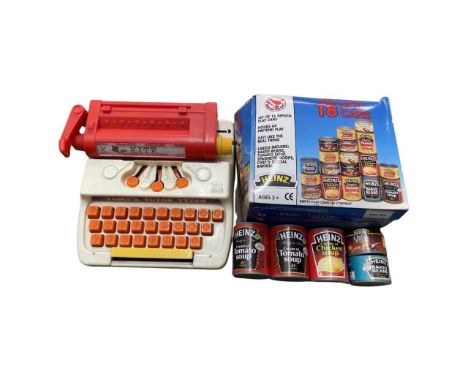 A pair of retro toys, to include: - A Tomy Tutor Typewriter - A boxed set of 18 Heinz play cans