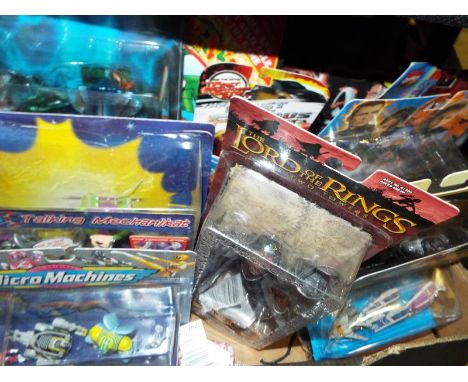 A collection of predominantly sealed blister packs to include Micro Machines, Batman Begins, Lord of the Rings The Two Towers
