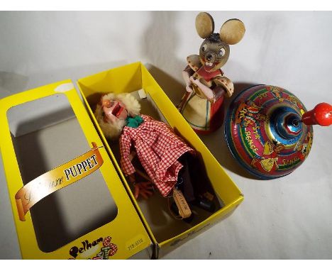 A Pelham Puppet, Farmer SM3, boxed, a tin-plate humming top by Chad Valley and a wooden depiction of a mouse with broom - (3)