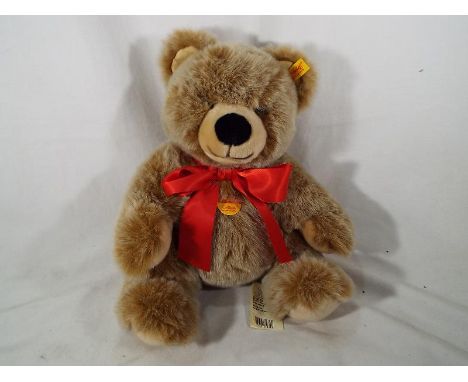 A light brown Steiff bear, button in ear with original paper label 33 cm (h)