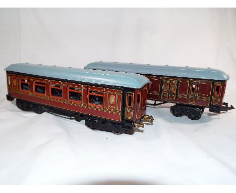 Model railways - two Bing tinplate O gauge bogie saloon coaches of which one with fitted internal tables and chairs and openi