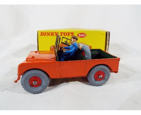 Dinky Toys - A Land Rover # 340, red body, green interior, red plastic hubs, blue plastic driver, in original light yellow bo