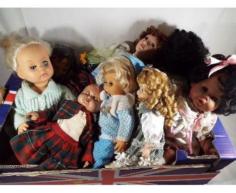 A collection of dressed dolls to include a bisque headed doll with jointed limbs, sleeping eyes, and similar