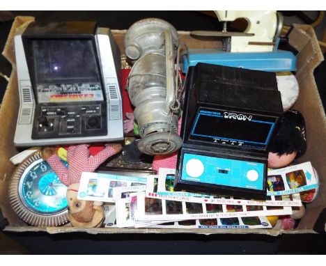 A good mixed lot of toys to include a Grandstand Tron Electronic Game, a Grandstand Firefox F-7, Chad Valley Give a Show slid