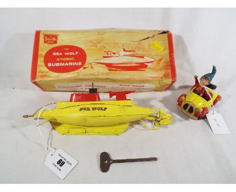 A Sutcliffe Model - Sea Wolf Atomic Submarine, clockwork, yellow body with gold coloured decal and red plastic fittings, blac