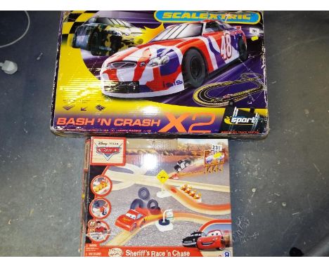 A Scalextric Bash and Crash X2 and a Disney Pixar Cars Sheriff Race and Chase car set, boxed (2)