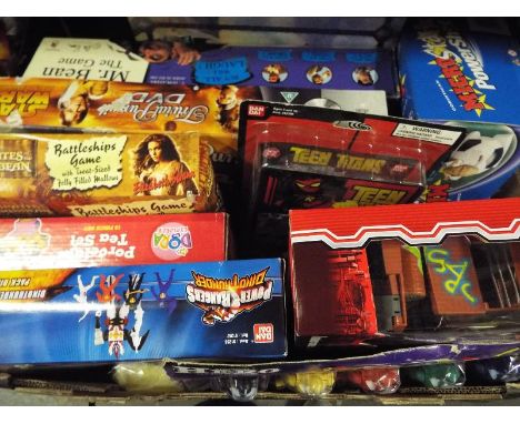 A mixed lot to include a collection of sealed blister packs, action figures and board games to include Teen Titans, Micro Mac