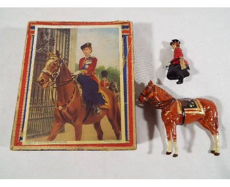 Queen Elizabeth II on horseback, sidesaddle 'trooping the colour', painted lead model probably by Benbros, 7.5 cm x 8.5 cm, o