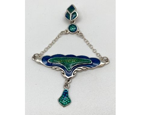 A silver Art Nouveau style pendant with blue and green coloured enamel detail. 3 sectional leaf shaped bale with suspended pe