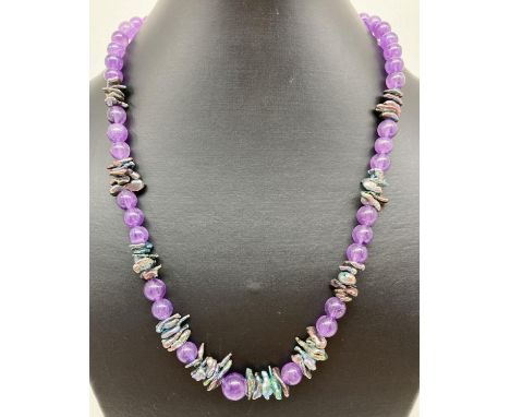 A very fine amethyst and fresh water peacock keshi pearl 20" necklace. With silver tone hook clasp. Retired jewellery makers 