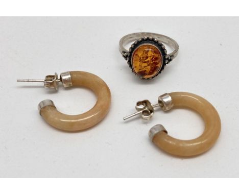 2 items of white metal and amber jewellery. A modern design ring set with an oval cabochon of cognac amber, together with a p