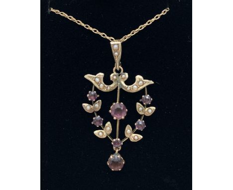 A 9ct gold Art Nouveau pendant set with seed pearls and amethyst stones. On a 9ct gold 18" fine rope chain, marked 375 to spr