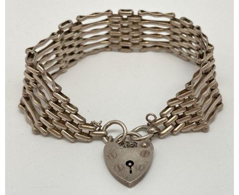 A vintage silver 6 bar gate bracelet with padlock shaped clasp and safety chain. Approx. 7.5 inches long. Hallmarks to back o