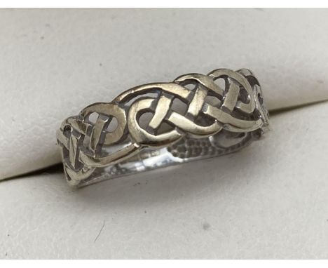 A small 9ct gold band ring with Celtic pierced work design. Full hallmarks to inside of band. Ring size H, approx. 1.1g. 