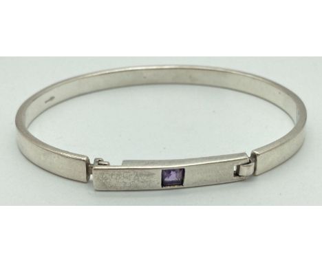 A silver modern design, full bangle style bracelet set with a square cut amethyst. Secure hook bar clasp. Full silver marks t