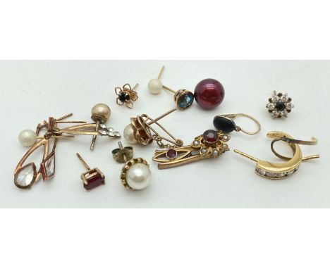 A small collection of odd scrap gold and stone set earrings. Marked or test as 9ct. Stones include blue topaz, amethyst, garn