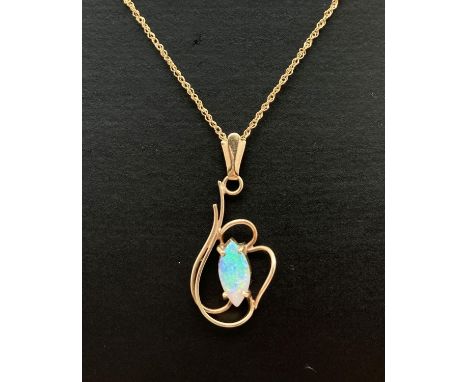 A 9ct gold wire style pendant set with a marquise cut opal. On an 18" rope chain marked 375 to spring clasp and joining link.