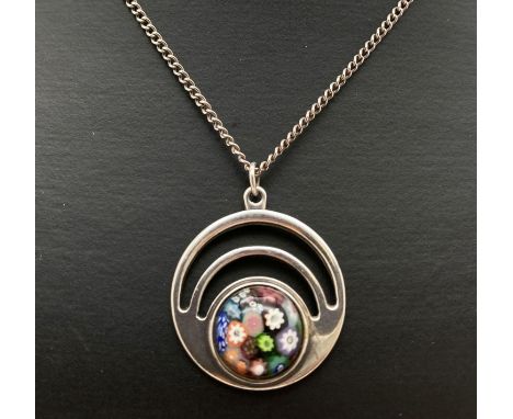 A Scottish silver circular shaped pendant set with Caithness millefiori glass cabochon. On a 20" curb chain with spring clasp