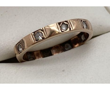 A vintage 9ct gold full eternity ring set with clear stones. Ring size K. Marked 9ct to inside of band. 