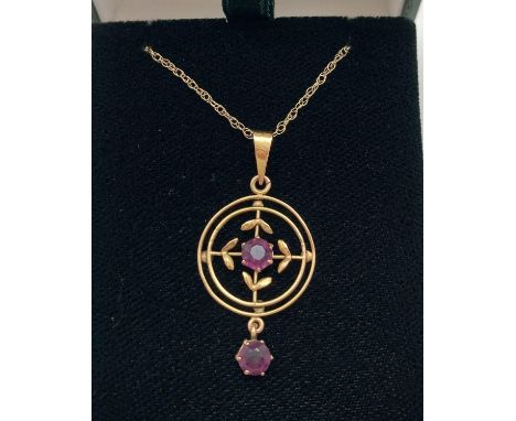 A 9ct gold Art Nouveau style pendant set with amethyst stones, on an 18" rope chain. Circular shaped pendant set with central