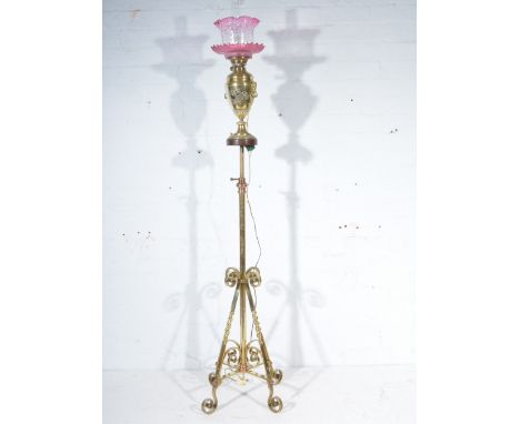 Edwardian brass oil lamp, urn shape form, cranberry glass shade with chimney, height 63cm overall, mounted on an associated a