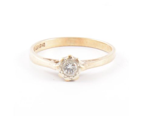 A diamond solitaire ring, the brilliant cut stone illusion set in a 9 carat yellow and white gold mount, ring size K.