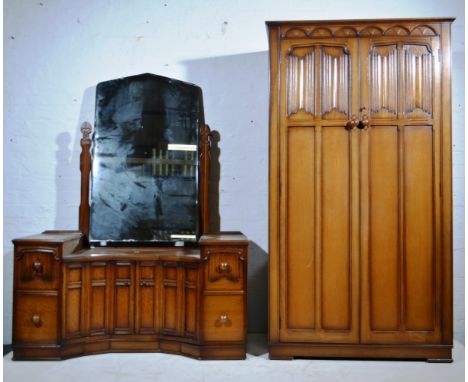 Oak bedroom suite, linen fold panel cupboards, headboard, dressing table, chest of drawers.