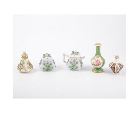 A German porcelain teapot, of small size, encrusted floral decoration, 10cm, with a matching sucrier and a collection of smal