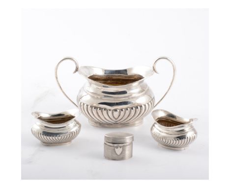 A silver sugar bowl, pair of salts and a snuff box. a half fluted sugar bowl, a pair of half fluted salts, an oval reeded snu