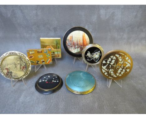 FOUR ASSORTED TRAVEL THEMED VINTAGE POWDER COMPACTS, to include an Austrian 'Mode Depose' suitcase style compact, a shaped co