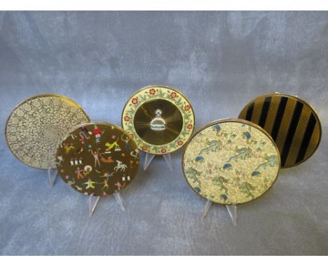 FIVE LARGE CIRCULAR VINTAGE VOGUE GARNITES POWDER COMPACTS, to include a lace pattern example, Oriental and circus themed exa