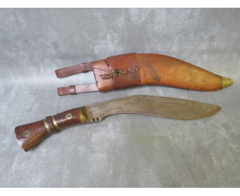 AN EARLY MILITARY KUKRI KNIFE, in leather covered wooden sheath, bearing date 1917 and inscription on blade, blade L 33 cm, o