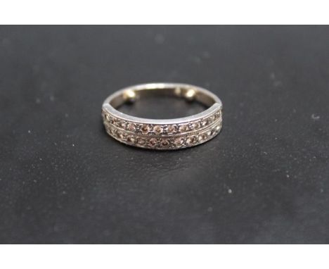 A TWIN ROW DIAMOND SET HALF ETERNITY RING, looks to have had a replacement shank with two resizing nodules added, metal is un