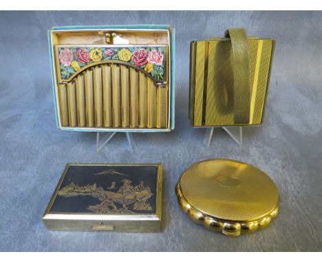 TWO VINTAGE MUSICAL COMPACTS, comprising a shaped Kigu example and a rectangular Clover example, together with a boxed Gwenda