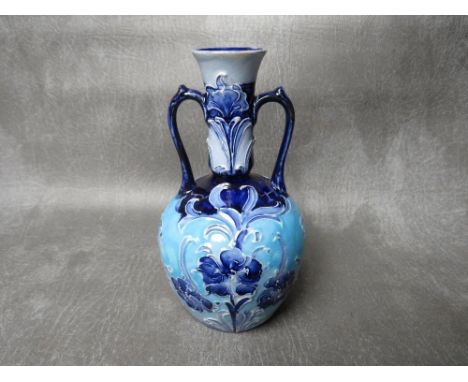 A MOORCROFT FOR MACINTYRE &amp; Co FLORIANWARE TWIN-HANDLED VASE, circa 1900, with impressed and printed marks to the base, H