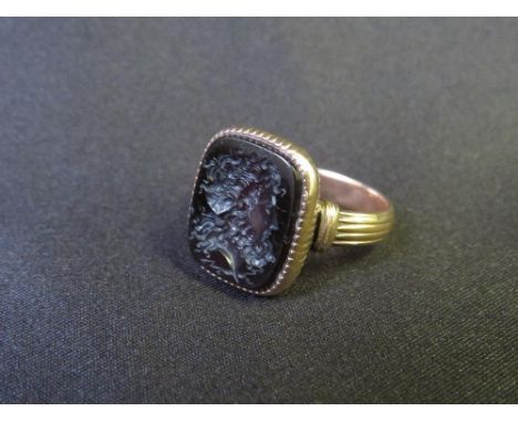 A GEORGIAN GOLD INTAGLIO CORNELIAN RING, of shaped rectangular form, unmarked and untested, approx. weight 6 g,&nbsp;ring siz
