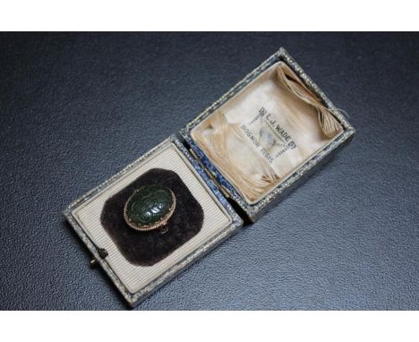 A HALLMARKED 9 CARAT GOLD CARVED OVAL JADE RING, carved with floral design, approx weight 5.4g, ring size N